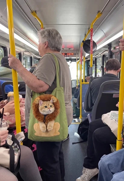 Cat traveling in a soft shoulder bag